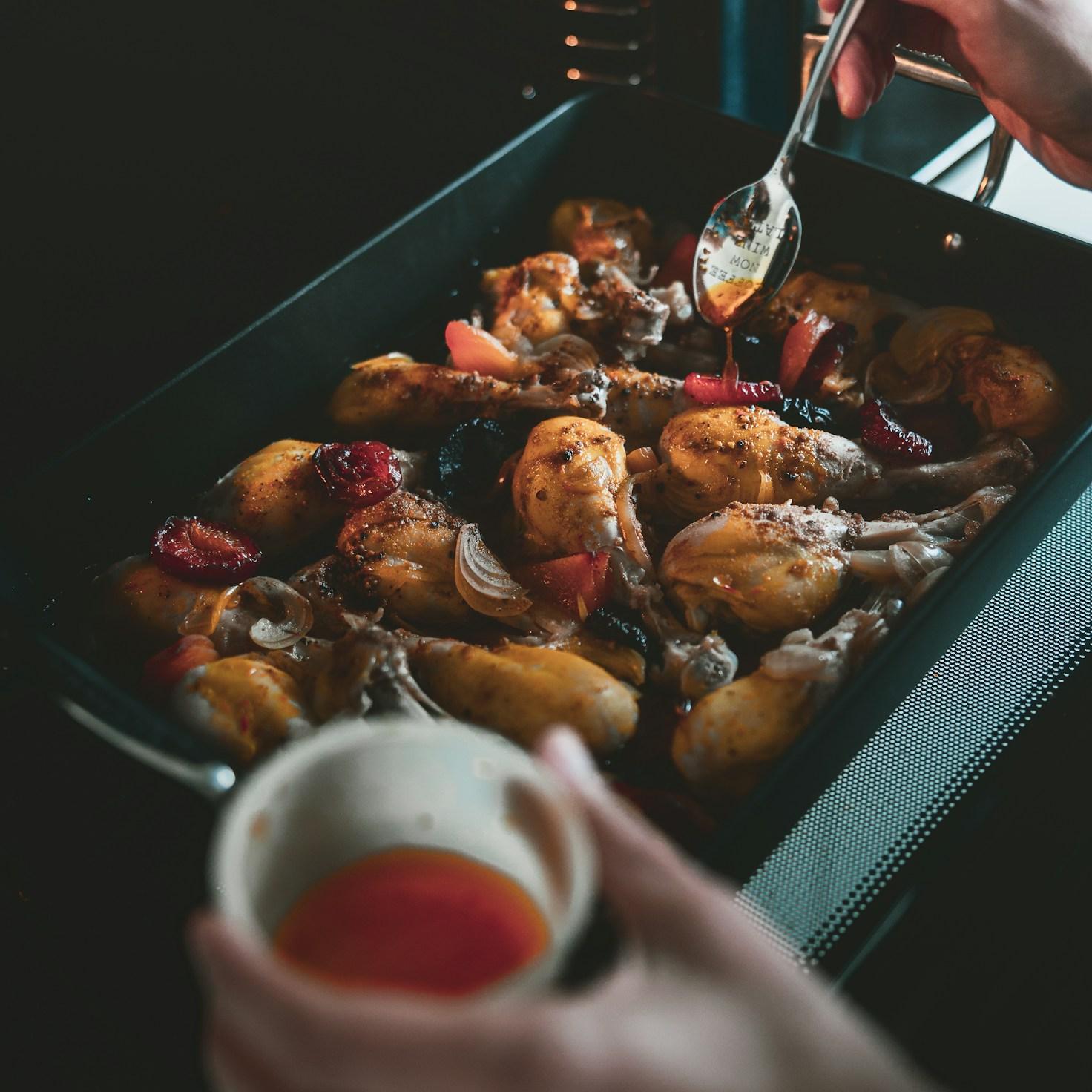 Community members collaborating in a contemporary kitchen, exchanging recipes and cooking methods
